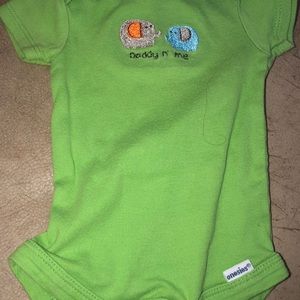 Mom and dad baby onesie together.